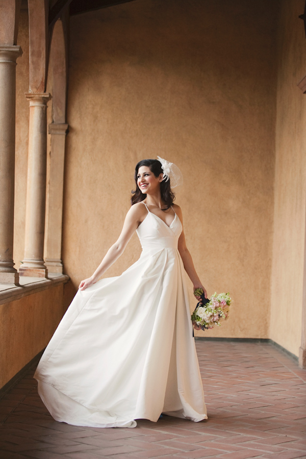 beautiful bride in ivory a line style gown with feather hair piece